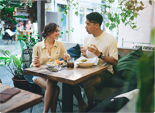 woman intrigued by man talking in cafe