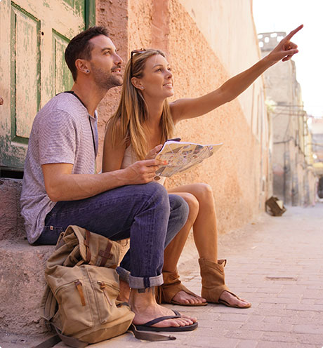 man and woman looking at map and poinging